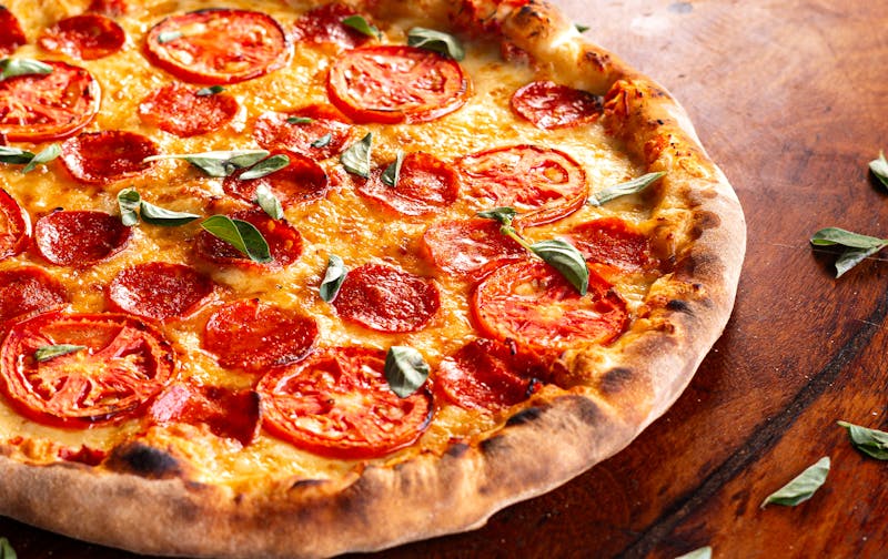 Jet's Pizza signature Margherita pizza with fresh basil and mozzarella