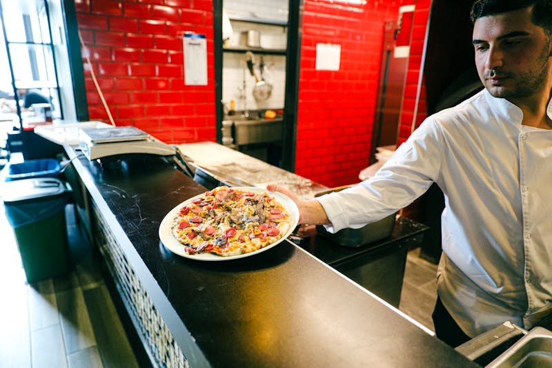 Jet's Pizza open kitchen where pizzas are crafted by hand